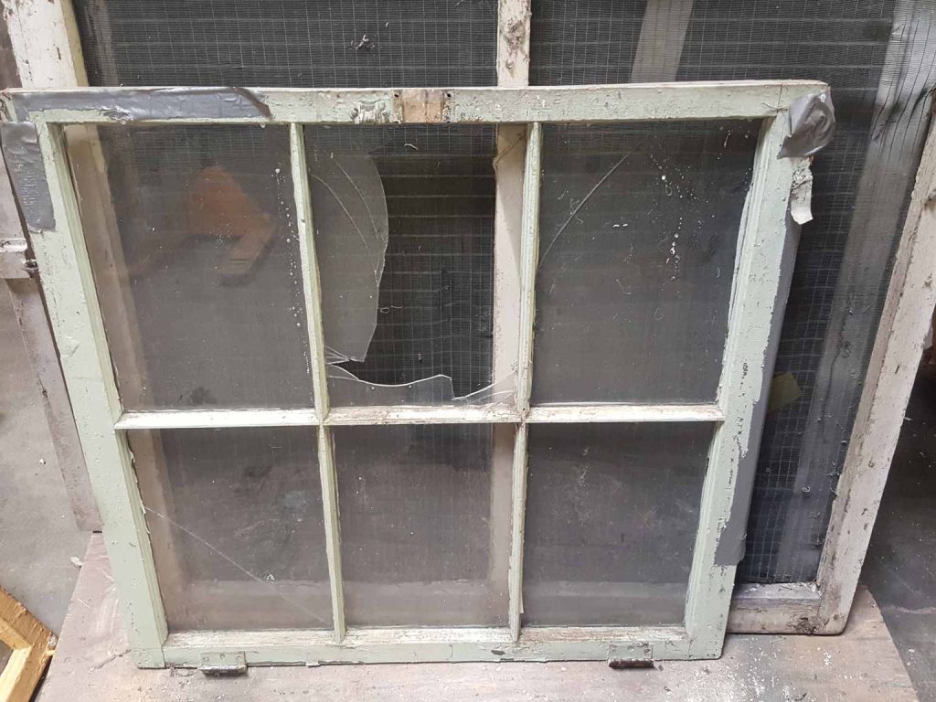 A detail view of one window prior to restoration.