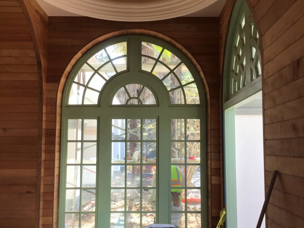 Looking from the inside out of one of the grand restored windows of Balboa Park Botanical Building