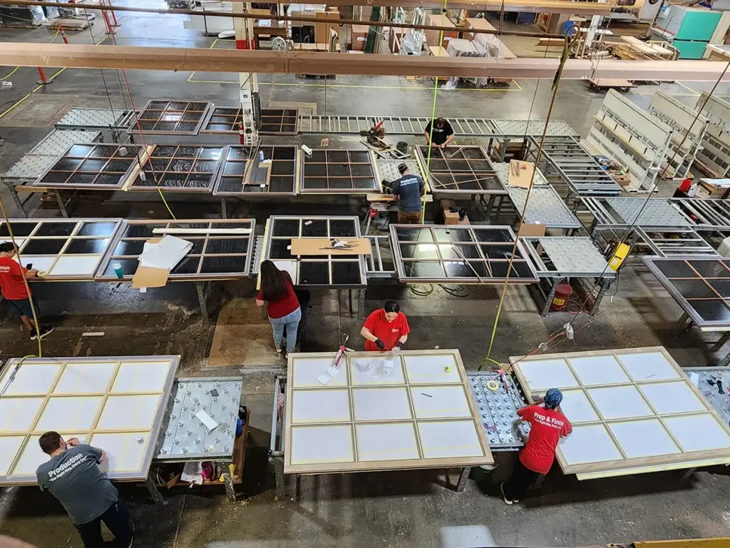Re-View team members working on window components for the Milwaukee Repertory Theater.