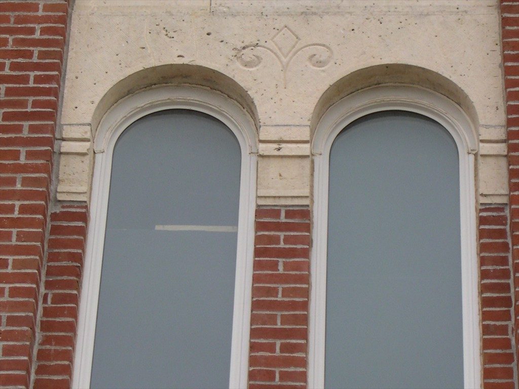 A close-up view of new replica arched windows.