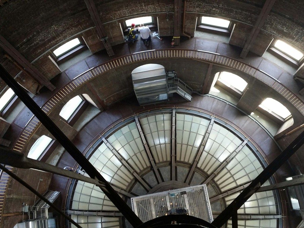 Workers assessing an interior window on the dome of the Kansas Statehouse.