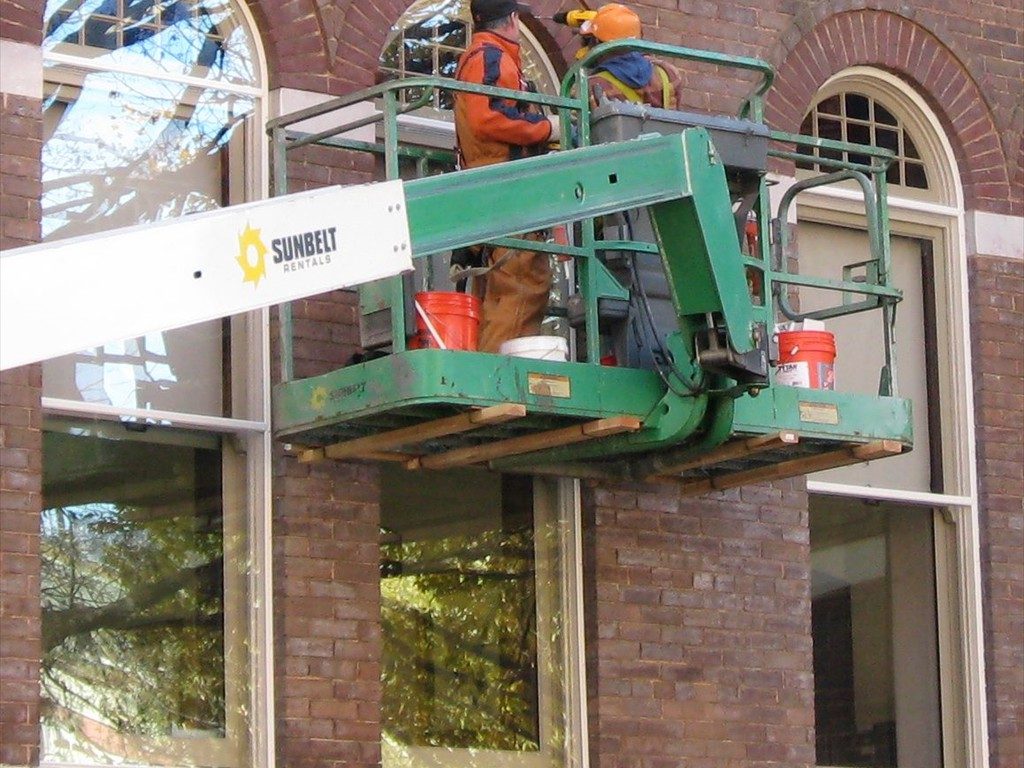 Workers install restored windows on the Knox County Courthouse.