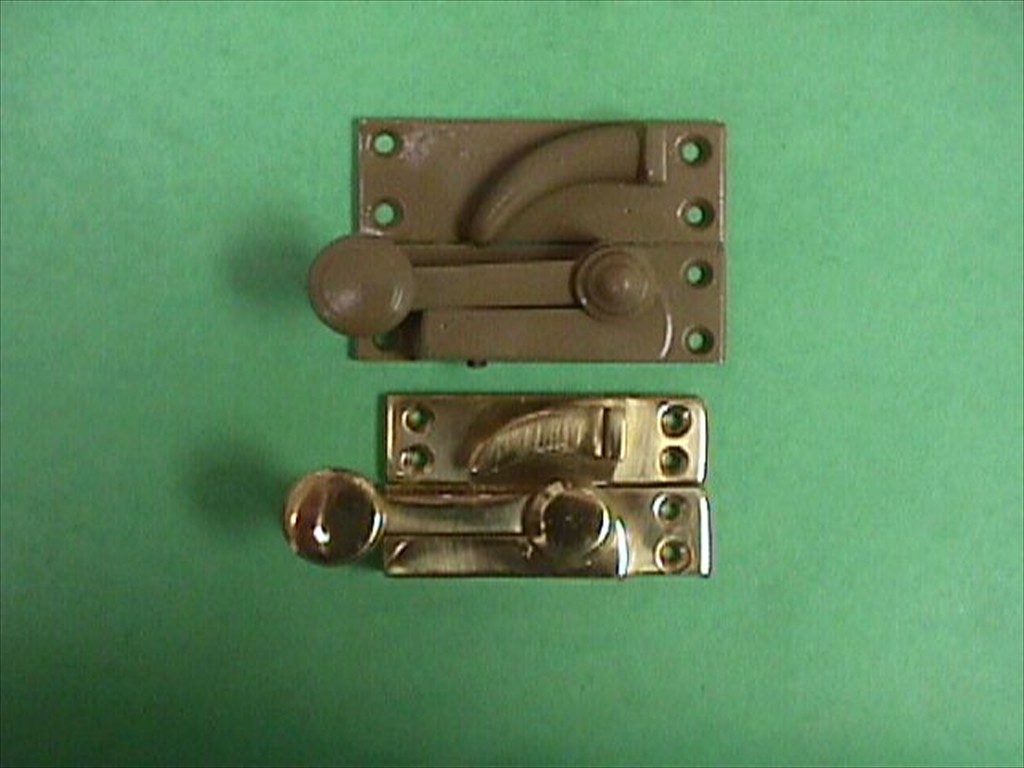 New custom window hardware shown below an older original.