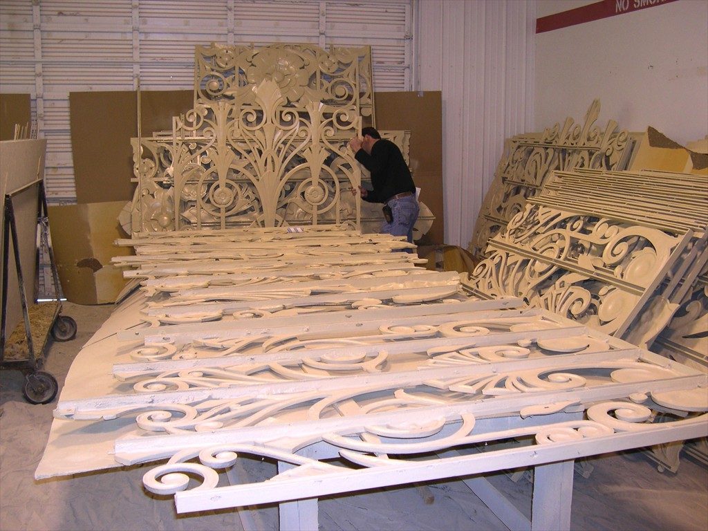 A worker handles window components in the shop.